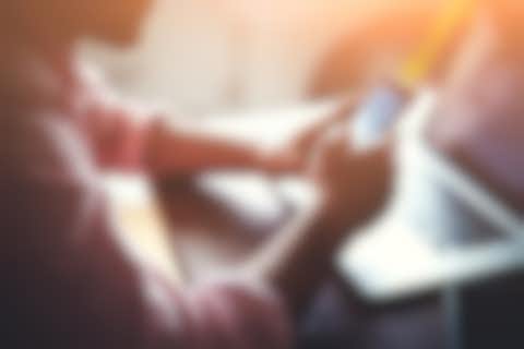 Man with smartphone and laptop